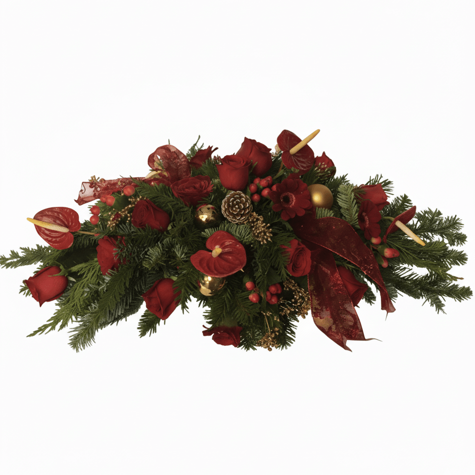 A festive holiday centerpiece featuring lush evergreen branches, red roses, red anthuriums, berries, pinecones, gold ornaments, and decorative red ribbon with candles nestled in the arrangement.