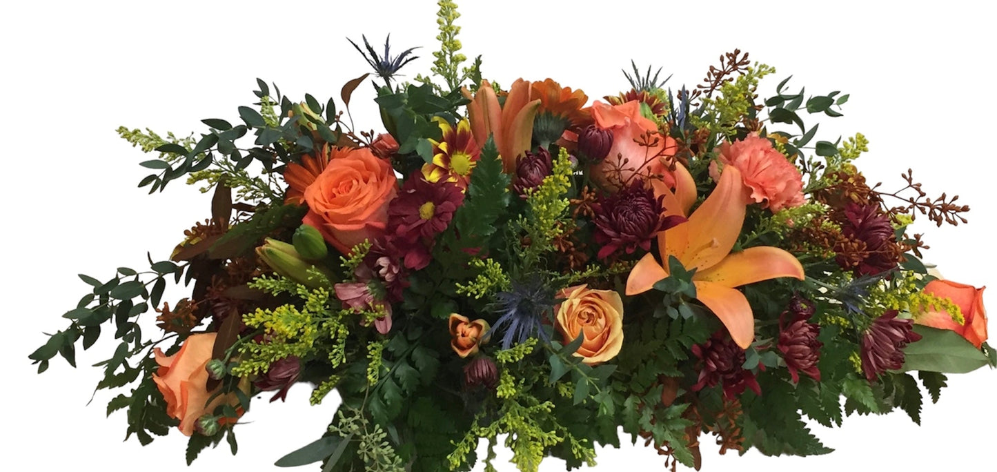 Bouquet of autumn flowers with orange, red, and green colors on a white background