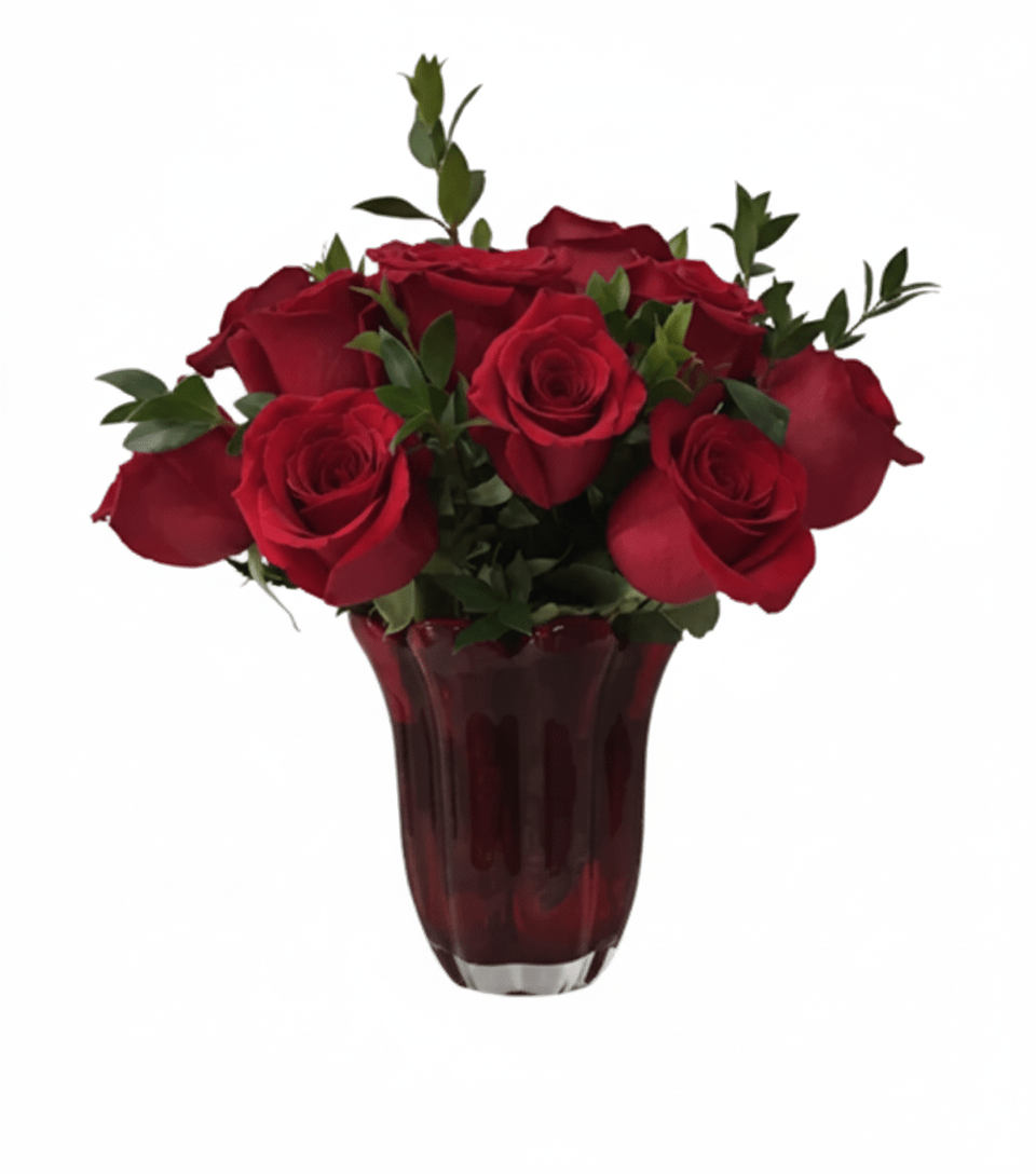 A lush arrangement named "Soulmate Love" featuring a bouquet of deep red roses and green foliage, beautifully arranged in a rich red fluted glass vase, set against a solid white background.