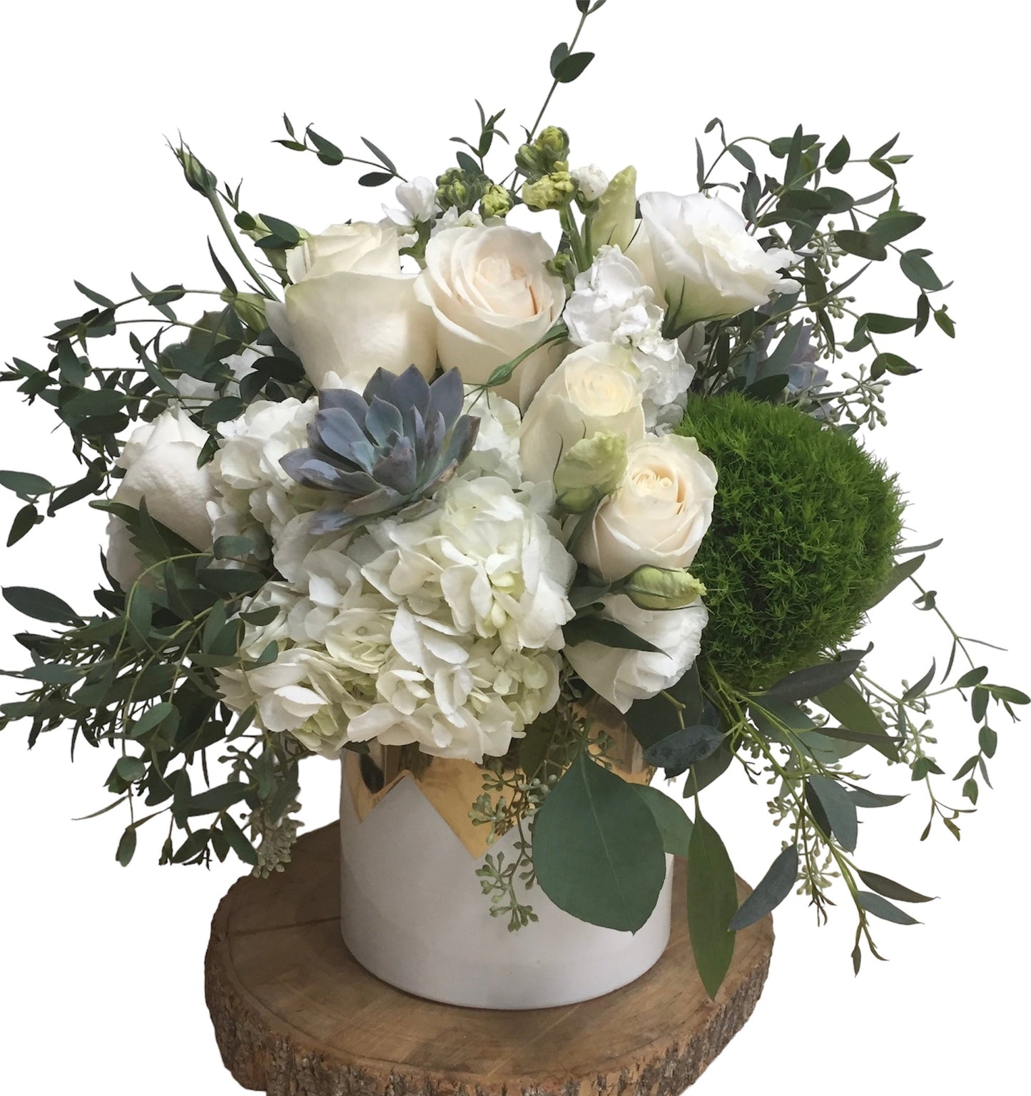 Floral arrangement with white flowers, greenery, and a small succulent in a decorative vase on a wooden base.