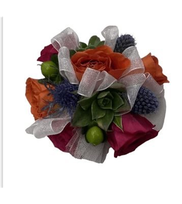 A vibrant wrist corsage featuring orange and fuchsia roses, a green succulent, blue thistle, small green decorative berries, and loops of shimmering white sheer ribbon, against a pure white background.