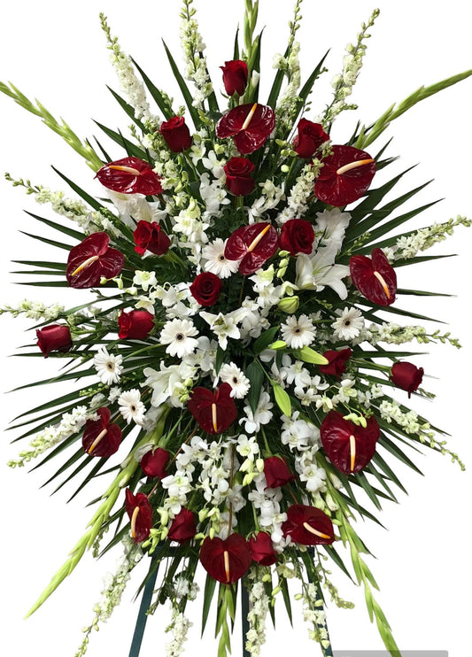 Funeral spray floral arrangement with red and white flowers on a white background
