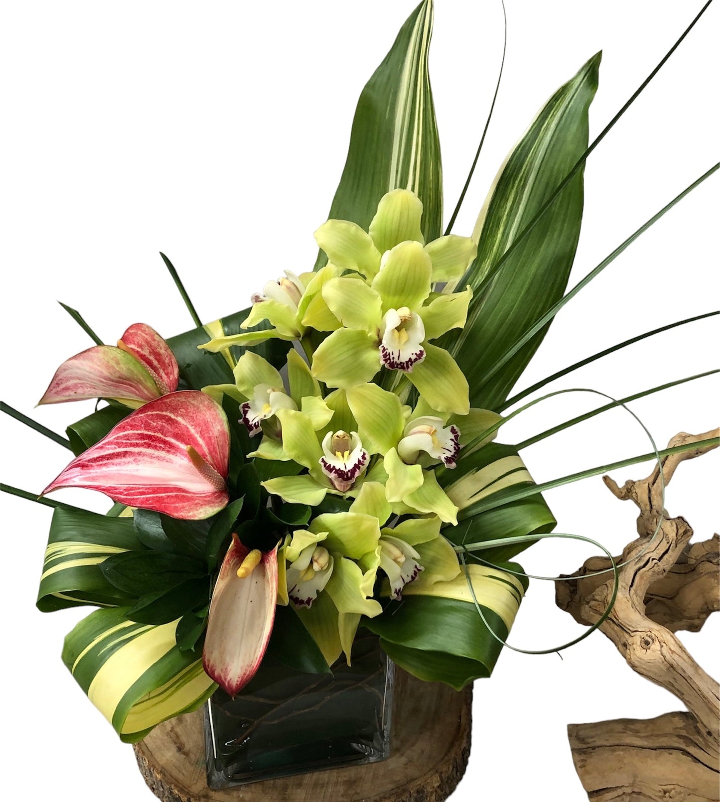Floral arrangement with green orchids, pink tulips, and green leaves on a white background