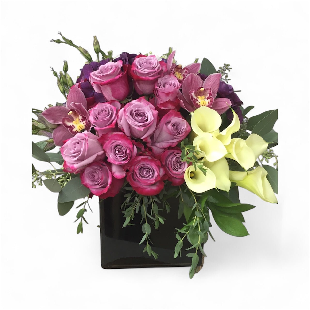 Bouquet of pink and purple roses with greenery on a white background