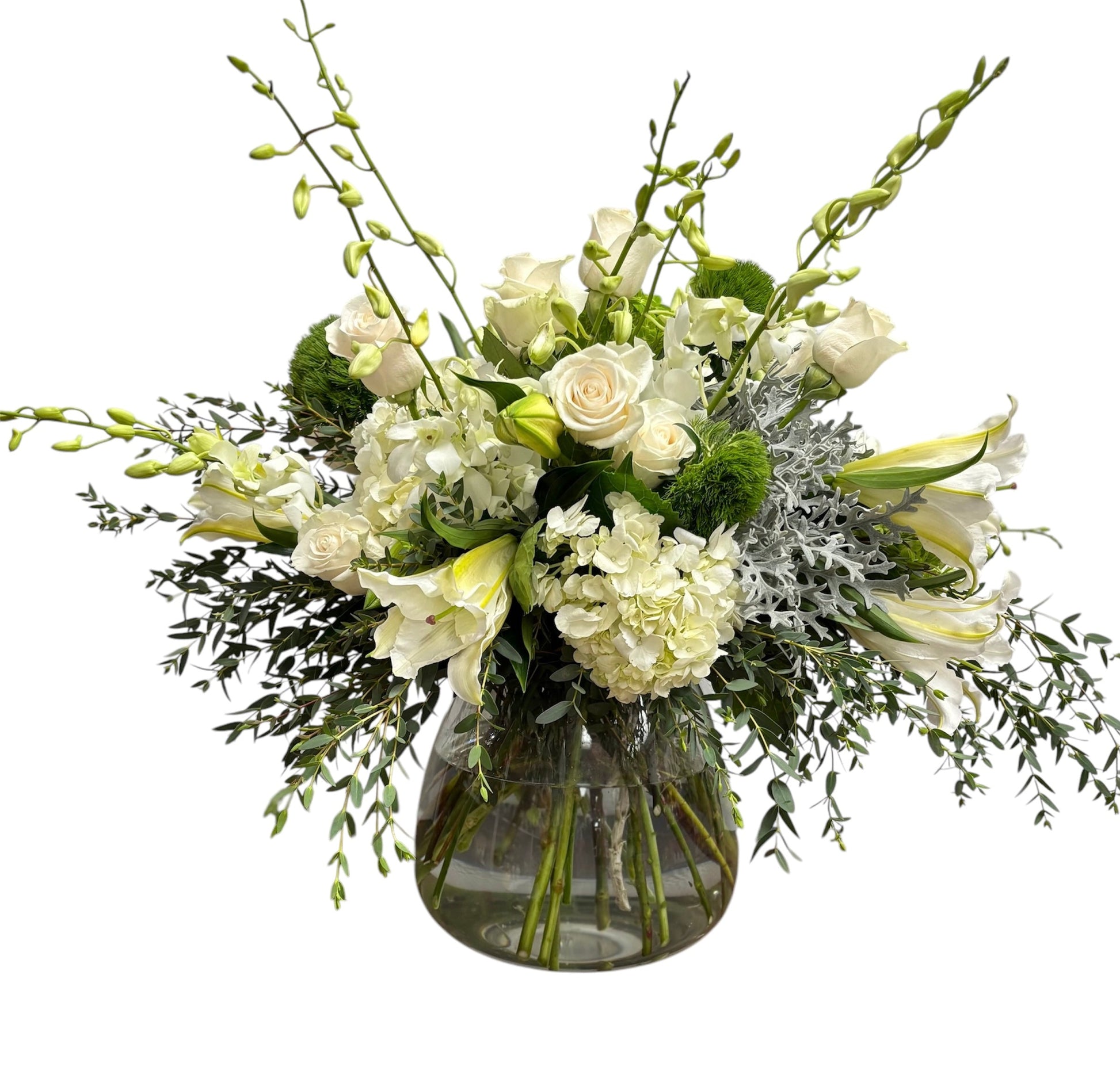 Bouquet of white and green flowers in a clear vase on a white background