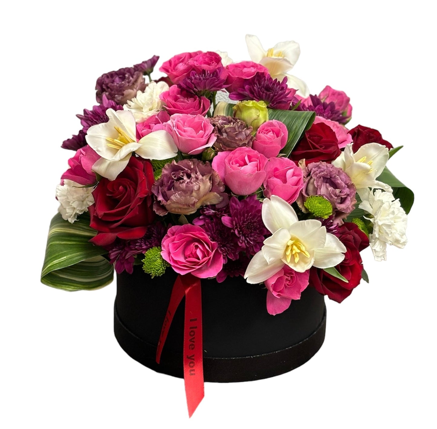 Colorful flower bouquet in a black valvet box with a red ribbon on a white background