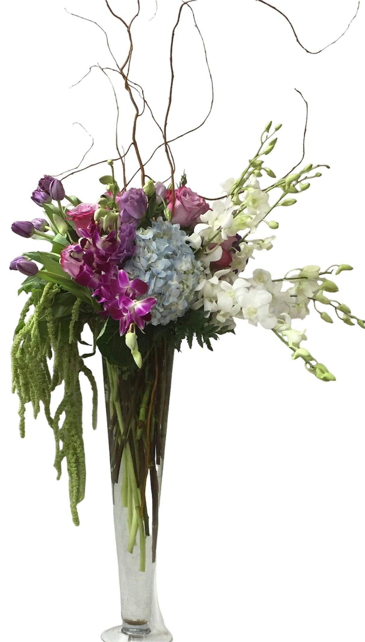 Wedding table floral arrangement in a clear vase on a white background