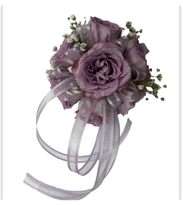 Purple floral corsage with ribbons on a white background