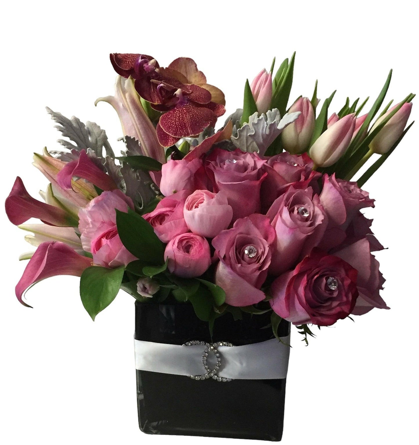 Bouquet of pink and purple flowers in a black vase with a silver ribbon on a white background