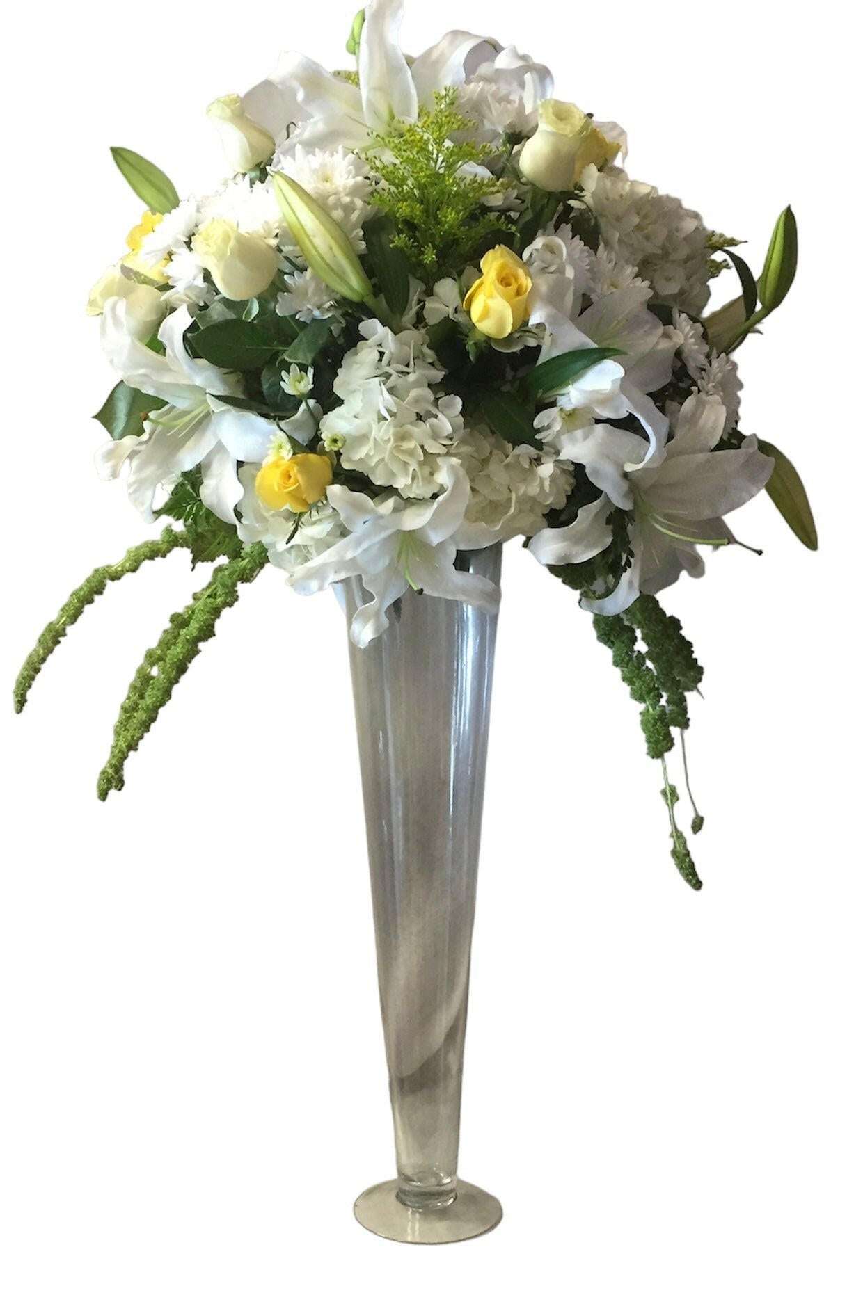 Floral arrangement with white lilies and yellow roses in a tall silver vase on a white background