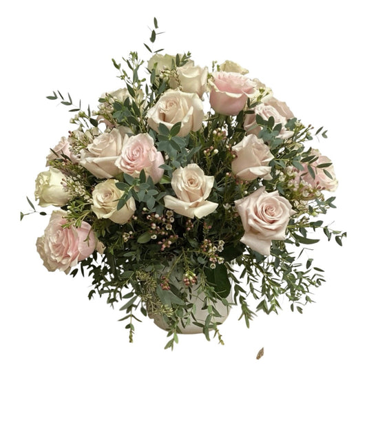 Bouquet of white and pink roses with greenery on a white background