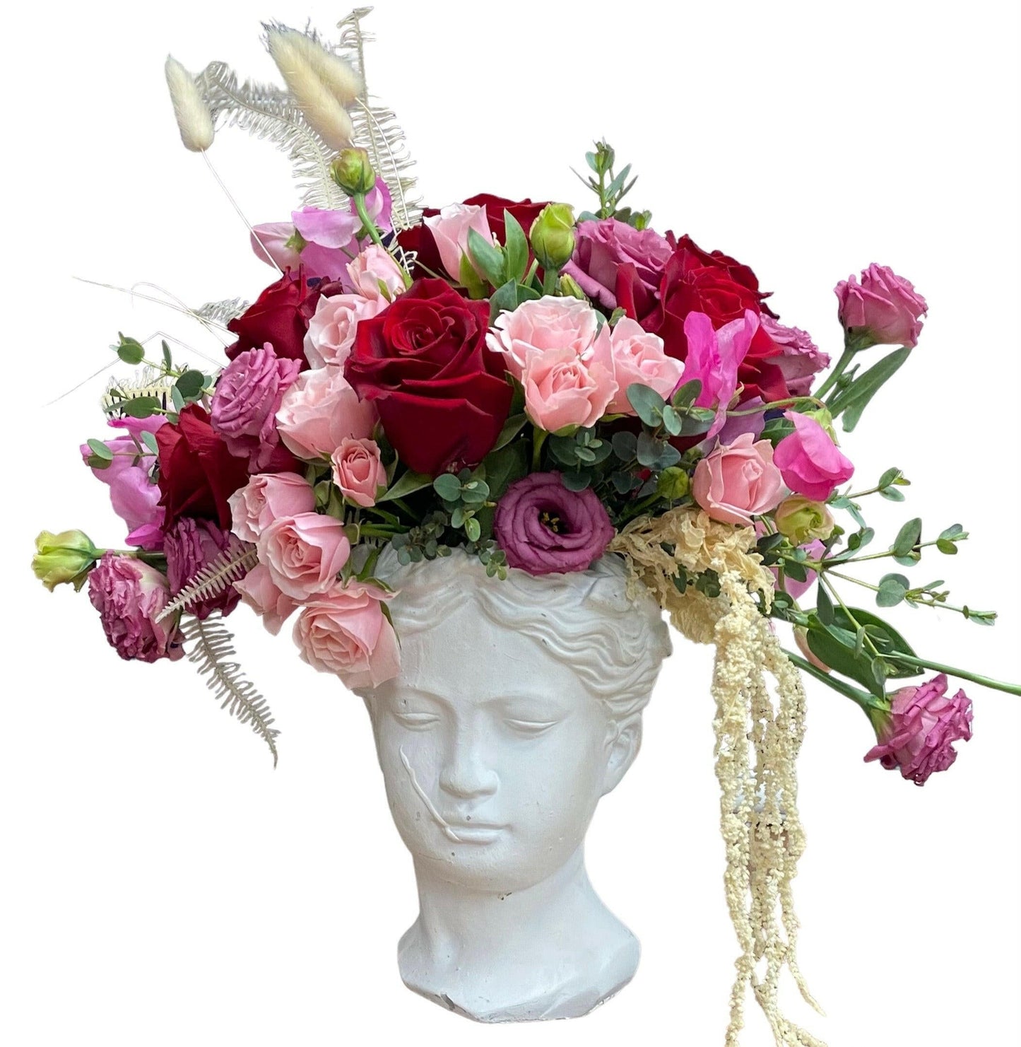 Floral arrangement on a white classical bust head 