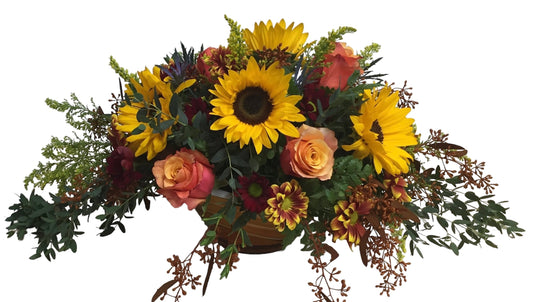 fall or Thanksgiving bouquet of sunflowers and roses with greenery on a white background