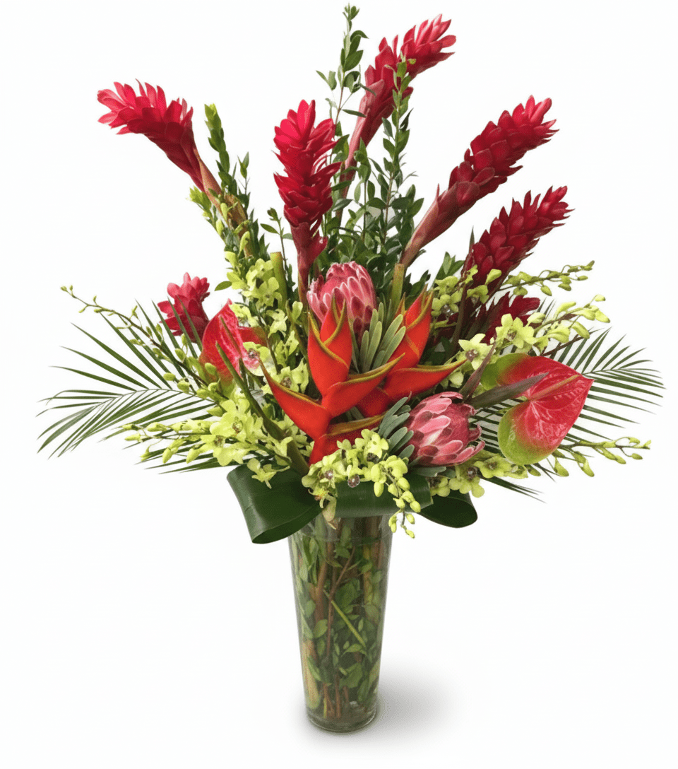 A vibrant tropical flower arrangement featuring tall red ginger, green dendrobium orchids, pink protea, red anthuriums, and palm leaves in a clear glass vase.
