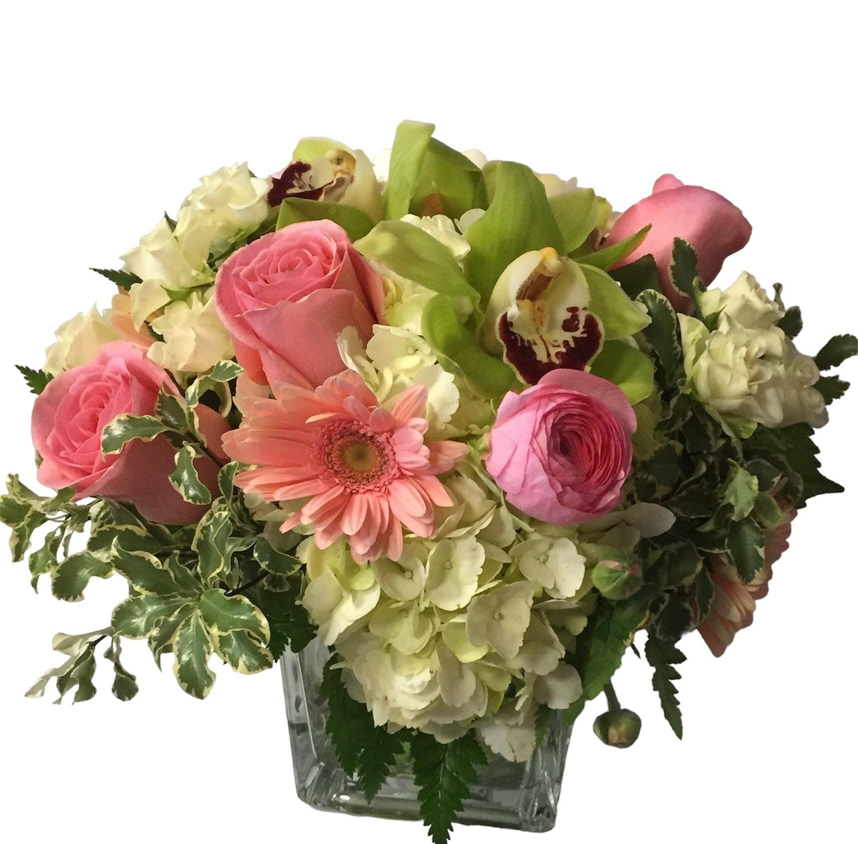 Bouquet of pink and green flowers in a clear vase on a white background