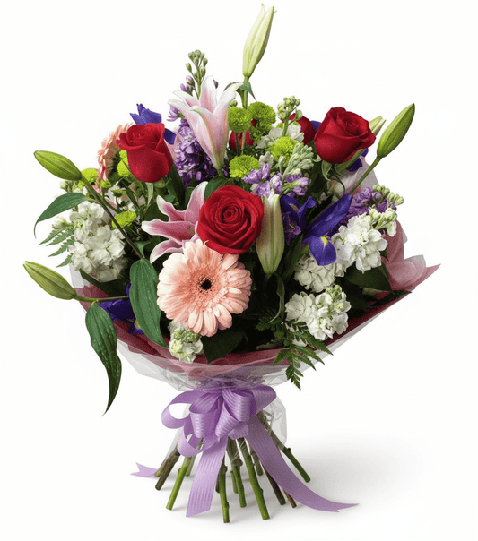 A colorful wrapped bouquet with red roses, pink lilies, and other mixed flowers.